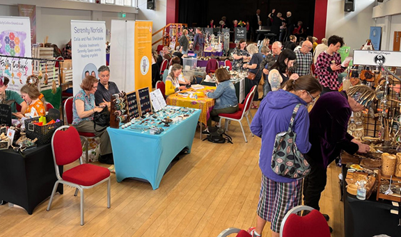Visitors browsing stalls at a community festival